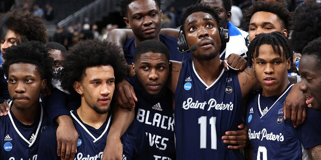 KC Ndefo #11 of the St. Peter's Peacocks celebrates with teammates after defeating the Murray State Racers 70-60 in the second round of the 2022 NCAA Men's Basketball Tournament at Gainbridge Fieldhouse on March 19, 2022, in Indianapolis, Indiana.