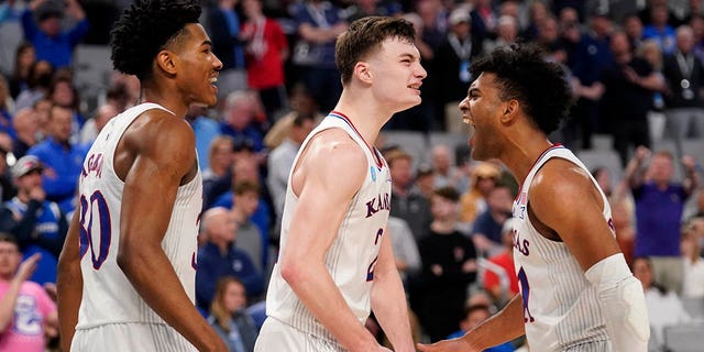 Kansas's Ochai Agbaji (30), Christian Braun (2) and Remy Martin, right, celebrate in the closing seconds of their second-round game against Creighton in the NCAA college basketball tournament in Fort Worth, Texas, Saturday, March, 19, 2022.