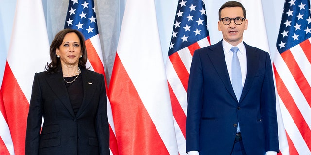 Polish Prime Minister Mateusz Morawiecki, right, and U.S. Vice President Kamala Harris pose for a photo as she arrives for a meeting, in Warsaw, Poland March 10, 2022. 