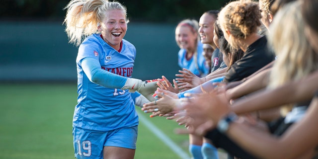 Stanford goalie Katie Meyer shakes hands with her teammates before a game.