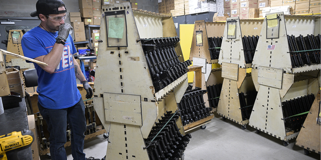 KelTec employee Bobby Cormier looks through lines of rifles, similar to ones being shipped to Ukraine, at their manufacturing facility on Thursday in Cocoa, Fla.