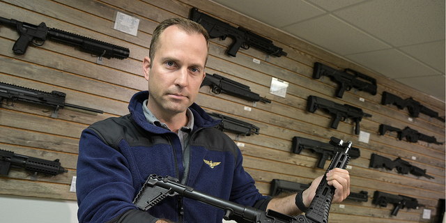 Adrian Kellgren, director of industrial production of KelTec, holds a 9mm SUB2000 rifle, similar to ones being shipped to Ukraine, at their manufacturing facility on Thursday.