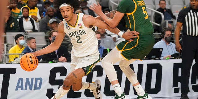 Baylor guard Kendall Brown (2) drives against Norfolk State guard Tyrese Jenkins (5) during the first half of a college basketball game in the first round of the NCAA tournament in Fort Worth, Texas, Thursday, March 17, 2022.