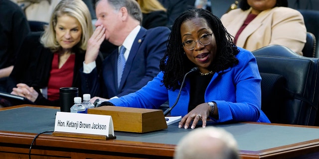 Supreme Court nominee Judge Ketanji Brown Jackson responds to a question from Sen. Thom Tillis, R-N.C., foreground, as she testifies before the Senate Judiciary Committee on Capitol Hill in Washington, Wednesday, March 23, 2022, during her confirmation hearing. (AP Photo/Susan Walsh)