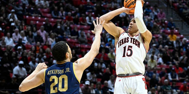 Texas Tech guard Kevin McCullar (15) shoots over Notre Dame forward Paul Atkinson Jr. (20) during the first half of a second-round NCAA college basketball tournament game, Sunday, March 20, 2022, San Diego.