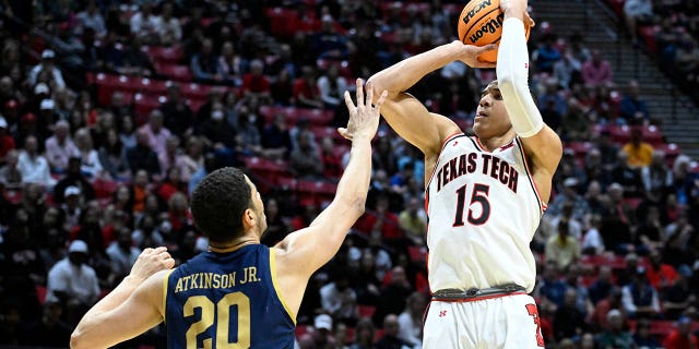 Texas Tech guard Kevin McCullar (15) shoots over Notre Dame forward Paul Atkinson Jr. (20) during the first half of a second-round NCAA college basketball tournament game, Sunday, March 20, 2022, San Diego.
