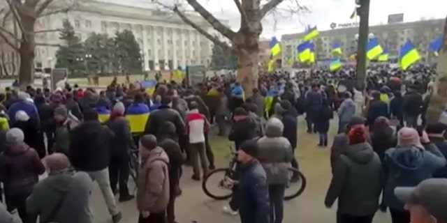 Ukrainians in Kherson rally against Russian forces after city's seizure.