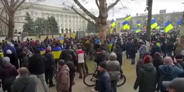 Ukrainians in Kherson rally against Russian forces after city's seizure.