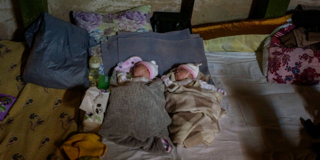Newborn twin brothers sleep in a basement used as a bomb shelter at the Okhmadet children's hospital in central Kyiv, Ukraine, Monday, Feb. 28, 2022.