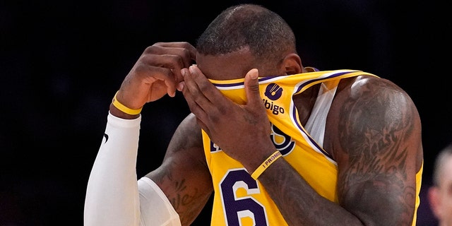 Los Angeles Lakers forward LeBron James wipes his face with his jersey during the first half of an NBA basketball game against the Dallas Mavericks Tuesday, March 1, 2022, in Los Angeles.