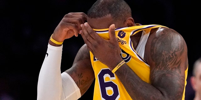Los Angeles Lakers forward LeBron James wipes his face with his jersey during the first half of an NBA basketball game against the Dallas Mavericks Tuesday, March 1, 2022, in Los Angeles.