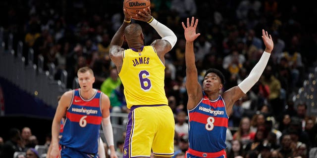 Los Angeles Lakers' LeBron James, #6, shoots as Washington Wizards' Rui Hachimura, #8, defends during the first half of an NBA basketball game, Saturday, March 19, 2022, in Washington.
