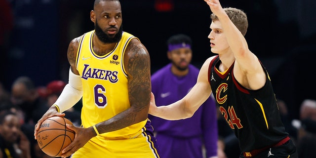 LeBron James (6) of the Los Angeles Lakers plays against Lauri Markkanen (24) of the Cleveland Cavaliers in the first half of an NBA basketball game, Monday, March 21, 2022, in Cleveland.