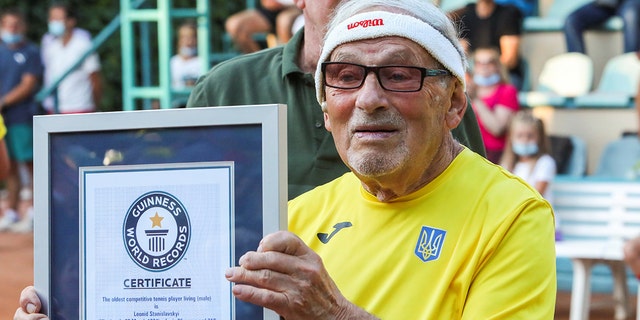 The world's oldest tennis player, Ukrainian Leonid Stanislavskyi, 97, attends a Guinness World Record certificate award ceremony in Kharkiv, Ukraine, July 7, 2021.