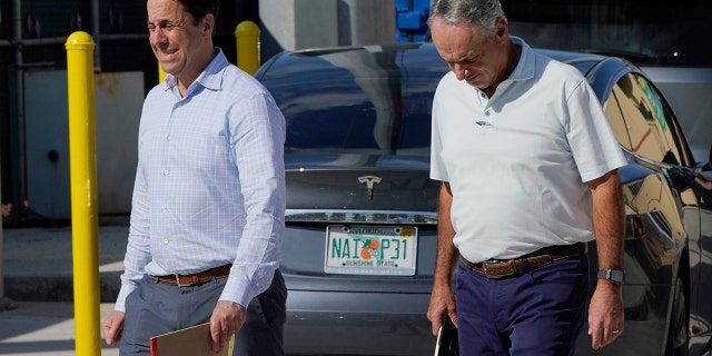 Major League Baseball Deputy Commissioner Dan Halem, left, and Commissioner Rob Manfred, right, walk after negotiations with the players association in an attempt to reach an agreement to salvage March 31 openers and a 162-game season, Monday, Feb. 28, 2022, at Roger Dean Stadium in Jupiter, Fla.