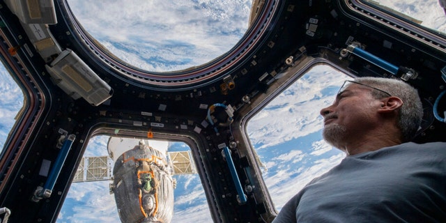 U.S. astronaut and Expedition 66 Flight Engineer Mark Vande Hei peers at the Earth below from inside the seven-windowed cupola, the International Space Station's window to the world on Feb. 4, 2022. (Kayla Barron/NASA via AP) 