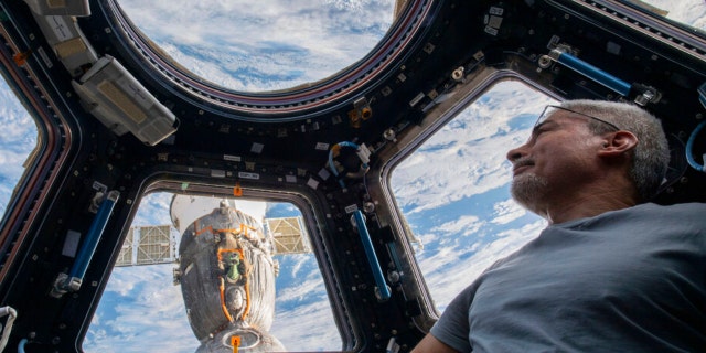 U.S. astronaut and Expedition 66 Flight Engineer Mark Vande Hei peers at the Earth below from inside the seven-windowed cupola, the International Space Station's window to the world on Feb. 4, 2022. (Kayla Barron/NASA via AP) 