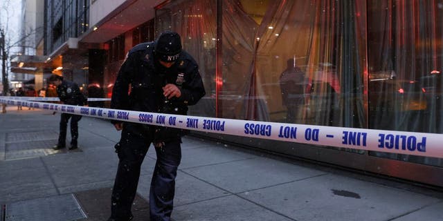 Members of the New York City Police Department (NYPD) search the area near the entrance of the Museum of Modern Art (MOMA) after an alleged multiple stabbing incident, in New York, U.S., March 12, 2022.