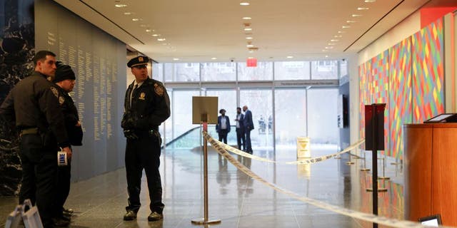 Members of the New York City Police Department (NYPD) search the area near the entrance of the Museum of Modern Art (MOMA) after an alleged multiple stabbing incident, in New York, U.S., March 12, 2022.