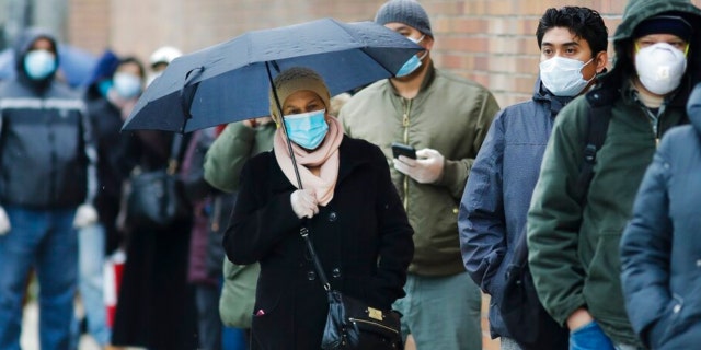 People line up at Gotham Health East New York, a COVID-19 testing center Thursday, April 23, 2020, in the Brooklyn borough of New York.