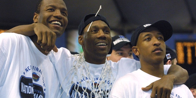 Casey Sanders, Nate James and Chris Duhon celebrate after defeating Arizona at the Metrodome in Minneapolis, Minnesota, on April 2, 2001.