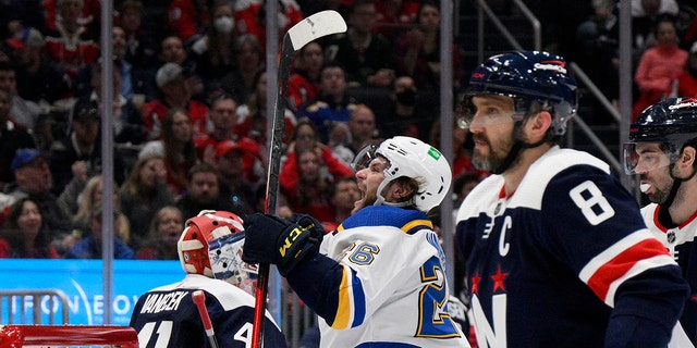 St. Louis Blues left wing Nathan Walker (26) celebrates his goal next to Washington Capitals goaltender Vitek Vanecek (41) and left wing Alex Ovechkin (8) during the second period of an NHL hockey game Tuesday, March 22, 2022, in Washington.