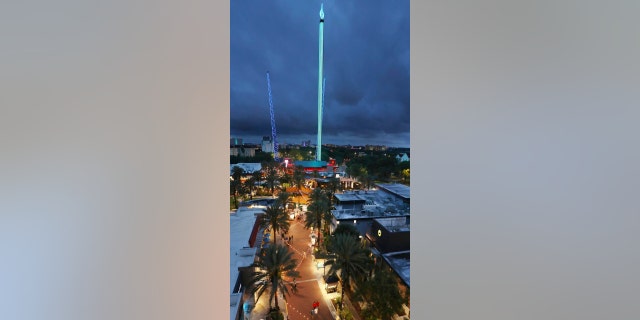 Tourists enjoy the rides and amenities at ICON Park in Orlando on Thursday, March 24, 2022. International Drive, long considered a tourist-centered stretch between Orlando's major theme parks, has thrived during the pandemic by rebranding itself as a place for locals to gather too. The Orlando FreeFall ride is pictured in the middle, towering over the restaurant area of the park. A 14-year-old boy died after falling from the Orlando FreeFall ride late Thursday evening.