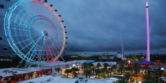 Tourists enjoy the rides and amenities at ICON Park in Orlando on Thursday, March 24, 2022. International Drive, long considered a tourist-centered stretch between Orlando's major theme parks, has thrived during the pandemic by rebranding itself as a place for locals to gather too. The Wheel at ICON Park is at left, Orlando SlingShot in middle, and Orlando FreeFall is at right. A 14-year-old boy died after falling from the Orlando FreeFall ride late Thursday evening. 