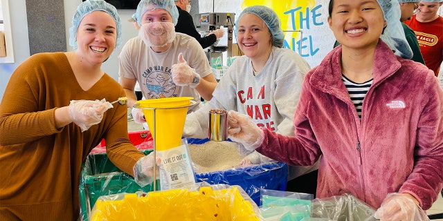 The Pack Shack volunteers helping pack meals for Ukraine refugees.