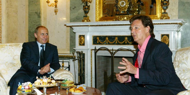 Putin listens to musician Sir Paul McCartney during their meeting at the Kremlin May 24, 2003, in Moscow.