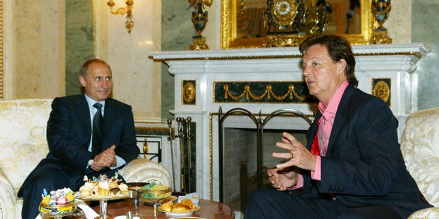 Putin listens to musician Sir Paul McCartney during their meeting at the Kremlin May 24, 2003, in Moscow.