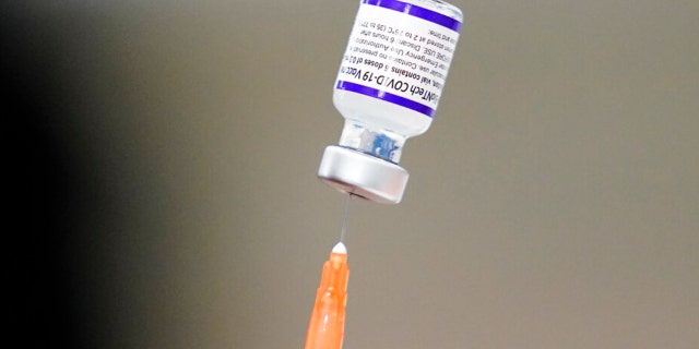 A syringe is prepared with the Pfizer COVID-19 vaccine at a vaccination clinic at the Keystone First Wellness Center in Chester, Pennsylvania, on Dec. 15, 2021.