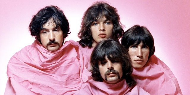 Psychedelic rock group Pink Floyd poses for a portrait shrouded in pink in August 1968 in Los Angeles. (L-R) Nick Mason, Dave Gilmour, Rick Wright (center front), Roger Waters.