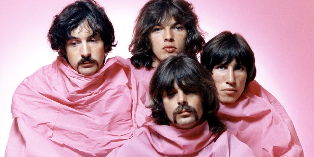 Psychedelic rock group Pink Floyd poses for a portrait shrouded in pink in August 1968 in Los Angeles. (L-R) Nick Mason, Dave Gilmour, Rick Wright (center front), Roger Waters.