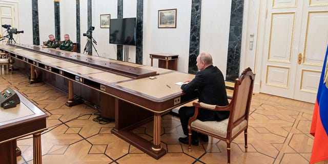 Russian President Vladimir Putin (right) talks with Russian Defense Minister Sergei Shoigu (second from left) and Chief of General Staff of the Russian Armed Forces and First Deputy Defense Minister Valery Gerasimov (left) during a meeting in Moscow, Russia, on February 2.  27, 2022. 
