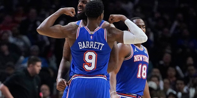 New York Knicks center Mitchell Robinson, center, celebrates his basket with RJ Barrett (9) during the second half of an NBA basketball game against the Los Angeles Clippers Sunday, March 6, 2022, in Los Angeles.