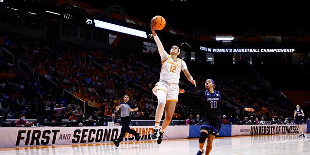 Tennessee guard Rae Burrell (12) shoots past Buffalo guard Dominique Camp (11) during the first half of a college basketball game in the first round of the NCAA Tournament, Saturday, March 19, 2022, in Knoxville, Tenn.