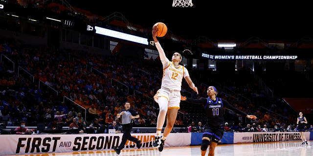 Tennessee guard Rae Burrell (12) shoots past Buffalo guard Dominique Camp (11) during the first half of a college basketball game in the first round of the NCAA Tournament, Saturday, March 19, 2022, in Knoxville, Tenn.