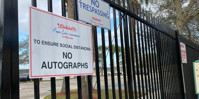 Signs are posted outside Roger Dean Stadium in Jupiter, Florida, Monday, Feb. 21, 2022. Baseball labor negotiations moved to the spring training ballpark from New York as players and owners join the talks, which enter a more intensive phase with perhaps a week left to salvage opening day on March 31.