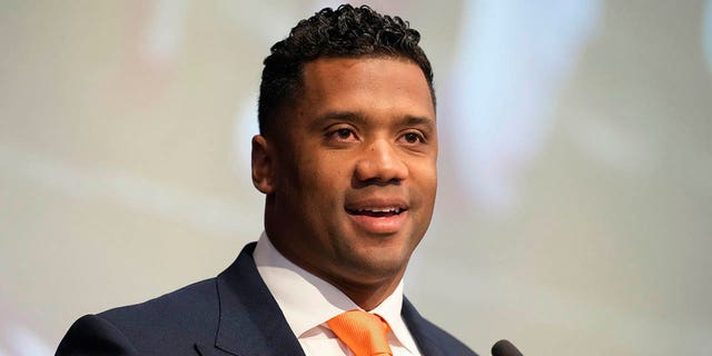 Denver Broncos new starting quarterback Russell Wilson speaks during a news conference Wednesday, March 16, 2022, at the team's headquarters in Englewood, Colo.
