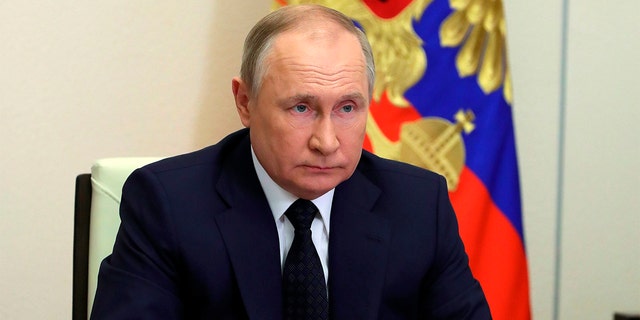 Russian President Vladimir Putin attends a cabinet meeting via videoconference outside Moscow on March 23, 2022.