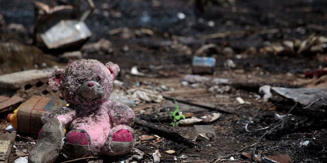 A doll is seen at a site of Saudi-led airstrikes targeting two houses in Sanaa, Yemen, Saturday, March 26, 2022. A Houthi media office claimed an airstrike hit houses for guards of the social insurance office, killing at least seven people and wounding three others, including women and children. 