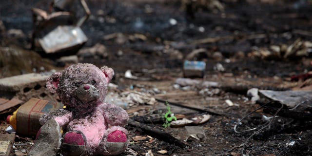 A doll is seen at a site of Saudi-led airstrikes targeting two houses in Sanaa, Yemen, Saturday, March 26, 2022. A Houthi media office claimed an airstrike hit houses for guards of the social insurance office, killing at least seven people and wounding three others, including women and children.