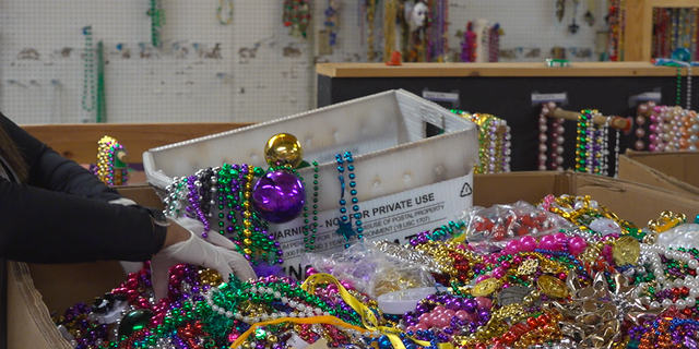 ArcGNO sorts through thousands of boxes of beads to resell for future parades. 