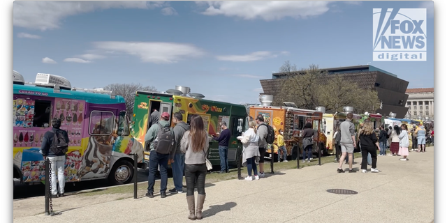 People line up to get lunch from food trucks in Washington, D.C.