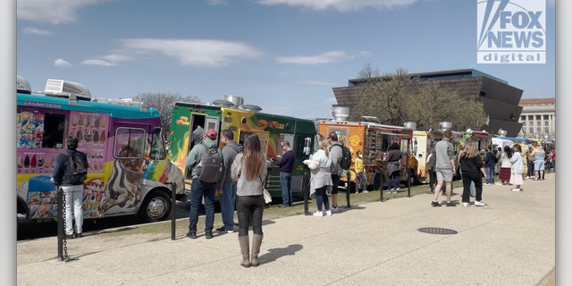 People line up to get lunch from food trucks in Washington, D.C.