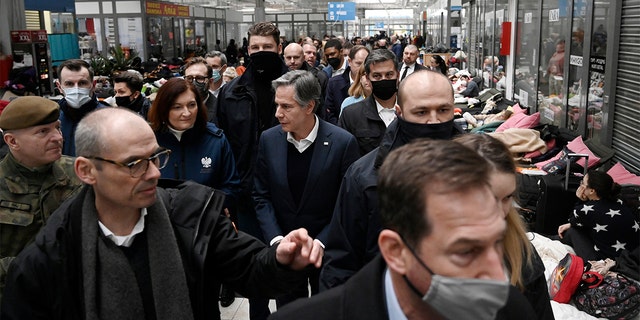 U.S. Secretary of State Antony Blinken, center, tours a reception center, for displaced persons from Ukraine, at the Ukrainian-Polish border crossing in Korczowa, Poland, Saturday, March 5, 2022. (Olivier Douliery, Pool Photo via AP)