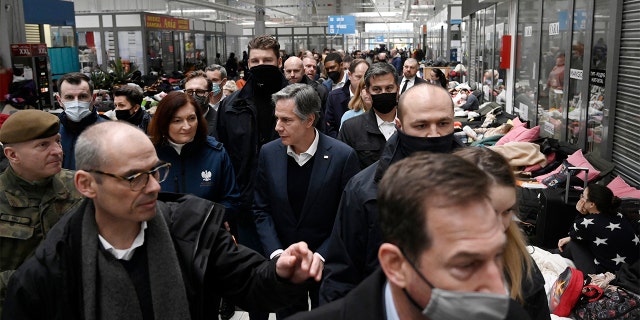 U.S. Secretary of State Antony Blinken, center, tours a reception center, for displaced persons from Ukraine, at the Ukrainian-Polish border crossing in Korczowa, Poland, Saturday, March 5, 2022.