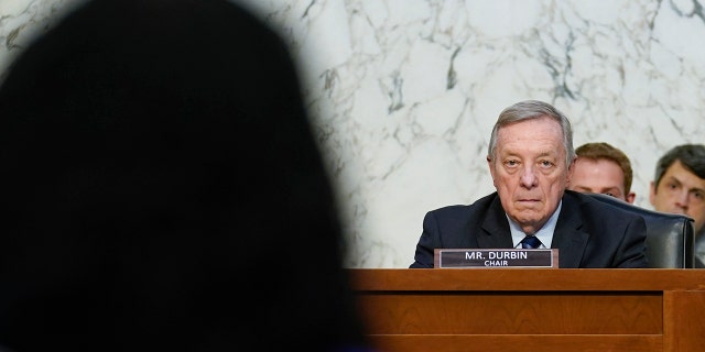 Sen. Dick Durbin, D-Ill., chairman of the Senate Judiciary Committee, listens as Supreme Court nominee Ketanji Brown speaks during her Senate Judiciary Committee confirmation hearing on Capitol Hill in Washington, Monday, March 21, 2022. 