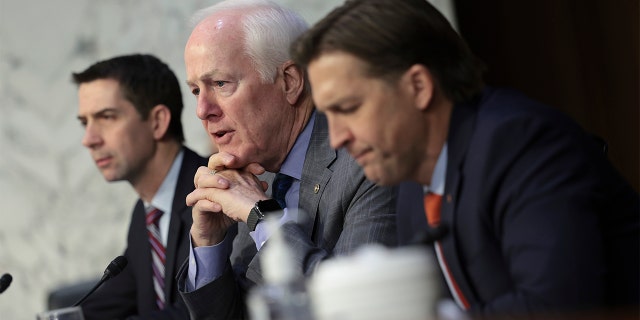Republican Sens. (from left) Tom Cotton, John Cornyn and Ben Sasse listen to testimony from leaders of the intelligence community during a Senate hearing March 10, 2022, in Washington.
